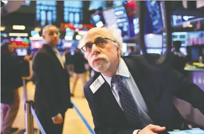 ?? GETTY IMAGES ?? Traders work at the New York Stock Exchange on Monday. The surge in coronaviru­s cases outside China has rocked stock markets.