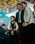  ??  ?? UST RECTOR Fr. Herminio Dagohoy, O.P. (middle); UST Christmas Concert organizing committee head Fr. Isidro Abaño, O.P., with a child chorister