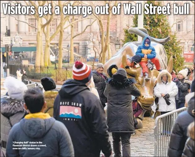  ?? ?? “Charging Bull” statue in the Financial District draws a crowd, even on chilly January day.