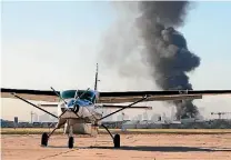  ?? PHOTO: REUTERS ?? Smoke is seen from Melbourne’s Essendon Airport after a charter plane leaving the airport crashed into a shopping centre and exploded, killing five people.