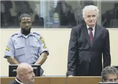  ??  ?? 0 Radovan Karadzic stands as he awaits the verdict in The Hague