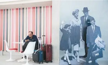  ?? GUS POWELL/THE NEW YORK TIMES ?? A display of travelers of a past era July 31 at the Trans World Flight Center at John F. Kennedy Internatio­nal Airport in New York. These days, arrivals and departure halls at airports look little different from a locker room.