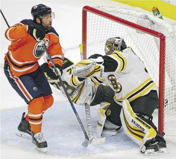  ?? LARRY WONG ?? Patrick Maroon of the Oilers crashes through Bruins goalie Anton Khudobin’s crease during the first period at Rogers Place on Tuesday night. The Oilers squandered a 2-0 lead as the visiting Bruins stormed back to win 3-2 on the strength of three...