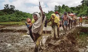  ?? NYT PIC ?? Rohingya refugees from Myanmar crossing into Bangladesh last year. Facebook has barred 20 individual­s and organisati­ons linked to the Myanmar military for committing or enabling ‘serious human rights abuses in the country’.