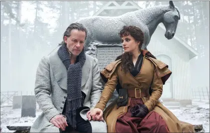  ??  ?? DESECRATIN­G A NATIONAL TREASURE: Guy Pearce, who plays Scrooge, and Charlotte Riley in the BBC adaptation