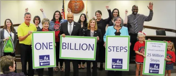  ?? SUBMITTED PHOTO ?? Chester County Commission­ers Terence Farrell, Michelle Kichline and Kathi Cozzone, center front, are joined by county health department staff and community partners to celebrate walking one billion steps in just six months.