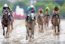  ?? PATRICK SEMANSKY/AP ?? Red Ruby, right, with Paco Lopez aboard, wins the Black-Eyed Susan as Coach Rocks, left, with Luis Saez aboard, comes in second at Pimlico race track on Friday.