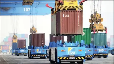  ?? PICTURE: AP ?? GOING UP: Automated cranes and transporte­rs move containers in a port in Qingdao in eastern China’s Shandong province. An official monthly survey shows that growth in China’s factory activity was steady last month.