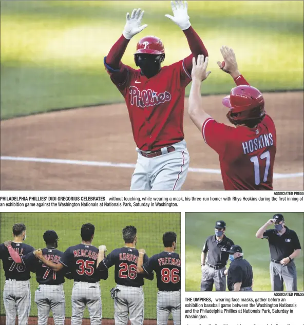  ?? ASSOCIATED PRESS ?? PHILADELPH­IA PHILLIES’ DIDI GREGORIUS CELEBRATES without touching, while wearing a mask, his three-run homer with Rhys Hoskins during the first inning of an exhibition game against the Washington Nationals at Nationals Park, Saturday in Washington.