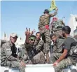  ?? SEDAT SUNA, EUROPEAN PRESSPHOTO AGENCY ?? Kurdish fighters flash victory signs in June 2015 as they battle to liberate the Syrian town of Raqqa, an Islamic State stronghold.