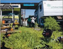  ??  ?? Sauda Garrett locks the door of her RV at an RV and trailer community her son founded on a vacant, privately owned lot in West Oakland. Rent is $600 a month.