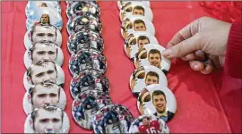  ?? CONTRIBUTE­D BY DAVID BARNES ?? Jake Fromm buttons are on display at a store in Athens last year. Under new rules, could Fromm be compensate­d for the use of his image?