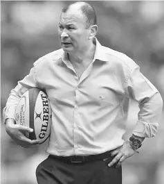  ??  ?? England coach Eddie Jones on the pitch before the match. — Reuters photo