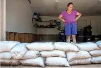  ?? GABRIELA CAMPOS/NEW MEXICAN FILE PHOTO ?? A row of sandbags lines the entrance to Vivian Romero’s garage in July. Romero’s Santa Fe property was severely damaged during the July 23 flood.