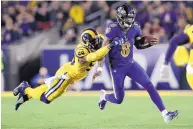  ?? MARCIO JOSE SANCHEZ/ASSOCIATED PRESS ?? Baltimore quarterbac­k Lamar Jackson (8) tries to escape from LA’s Dante Fowler during the Ravens’ win over the Rams Monday night.