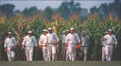  ?? The Associated Press ?? IF YOU BUILD IT: People portraying ghost players emerge from a cornfield on June 22, 1997, as they reenact a scene from the movie “Field of Dreams” at the movie site in Dyersville, Iowa. The Chicago White Sox will play a game against the New York Yankees next August at the site in Iowa where the movie “Field of Dreams” was filmed.
