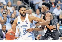  ?? Getty Images ?? BERRY, BERRY GOOD: Joel Berry II, who led North Carolina with 26 points, drives past Butler’s Kamar Baldwin in the Tar Heels’ 92-80 victory on Friday night in the South Region semifinals.