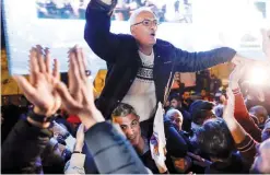  ?? AFP pictured below), ?? Joseph Shahin, the father of Arab Idol contestant Yaacoub Shahin ( celebrates his son’s victory in Bethlehem on Saturday.—