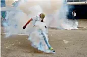  ?? — PTI ?? A demonstrat­or clashes with police during a rally against Venezuelan President Nicolas Maduro, in Caracas on Thursday.