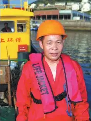  ?? PHOTOS BY HUA ZHIBO / FOR CHINA DAILY ?? Yang Shichai on board his garbage collection ship Canghai No 9 in the East China Sea.