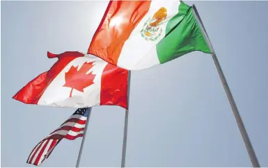  ?? JUDI BOTTINI, AP ?? Flags representi­ng the U.S., Canada and Mexico fly in New Orleans during NAFTA meetings in 2008.