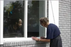  ?? The Associated Press file ?? Nursing home resident Wayne Swint is visited in June by mother Clemittee Swint in Warner Robins, Ga. Vaccinated nursing home residents can get hugs again from their loved ones, and indoor visits may be allowed for all residents, the government said.