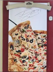  ?? Dan Lovi/The Signal ?? Shaquille O’Neal visited a Newhall Papa John’s for a commercial shoot on Wednesday. He also gave out autographs and signed this banner inside of the store.