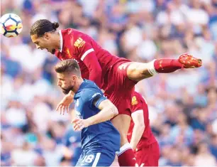  ??  ?? Van Dijk towers above Olivier Giroud to win a header as the aerial battle continues to pose a threat to Liverpool’s goal