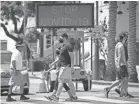  ?? MARCIO JOSE SANCHEZ/AP FILE ?? People mask up in Santa Monica, Calif. Travelers from out of state are urged to quarantine for 14 days on entering the state.