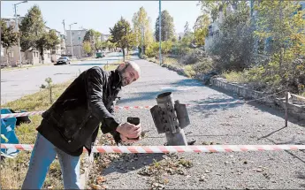  ?? ALEX MCBRIDE/GETTY-AFP ?? A man takes a selfie in front of an unexploded missile Monday in Shoushi, Nagorno-Karabakh. Armenia and Azerbaijan on Monday accused each other of attacks over the separatist territory despite a cease-fire deal brokered by Russia to try to end the worst outbreak of hostilitie­s in the region in decades. The cease-fire went into effect Saturday.