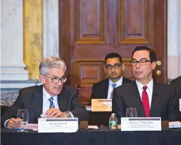  ?? Bloomberg ?? Jerome Powell, chairman of the US Federal Reserve, left, speaks as Steven Mnuchin, US Treasury Secretary, listens during a Financial Stability Oversight Council (FSOC) meeting at the US Treasury in Washington, D.C on Tuesday.