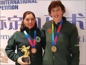  ??  ?? Cork equestrian­s Elaine Dolan Crowley and Mhuscraí native Mairead Ní Mhuimhneac­hain proudly wearing the medals they won in China.