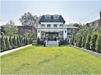  ??  ?? The L-shaped backyard has a covered deck, a landscaped lawn with gardens and an artist’s studio with two glass entry doors.