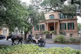  ??  ?? A carriage tour passes in front of the Owens-Thomas House and Slave Quarters in Savannah, Ga., which is owned by Telfair Museums and has been leading efforts to focus tours on the enslaved people who lived in the house.