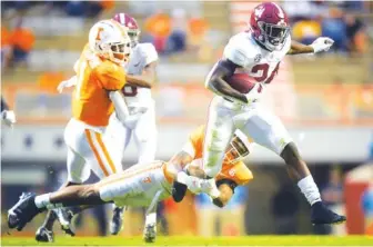  ?? CAITIE MCMEKIN/ KNOXVILLE NEWS SENTINEL VIA AP ?? Alabama running back Trey Sanders (24) is tackled by Tennessee defensive back Tamarion McDonald (21) during the fourth quarter Saturday in Knoxville.