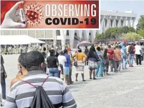  ?? (Photo: Karl Mclarty) ?? Jamaicans wait in line at the National Arena in St Andrew earlier this month on the final day of the Government’s COVID-19 vaccinatio­n blitz.