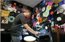  ?? MARK HUMPHREY — THE ASSOCIATED PRESS ?? Tyler Bryant listens to finished record albums for flaws in a quality control room at the United Record Pressing facility in Nashville, Tenn. Record sales that topped $1billion last year.