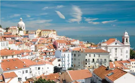  ?? CAMERON HEWITT ?? Breathtaki­ng views are bountiful in Miradouro Santa Luzia, a city of red-tiled roofs on the yawning mouth of the Tejo River.