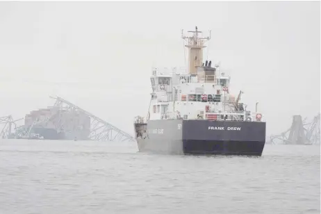  ?? — AFP photo ?? The US Coast Guard working at the scene after the cargo ship Dali collided with the Francis Scott Key Bridge causing it to collapse.