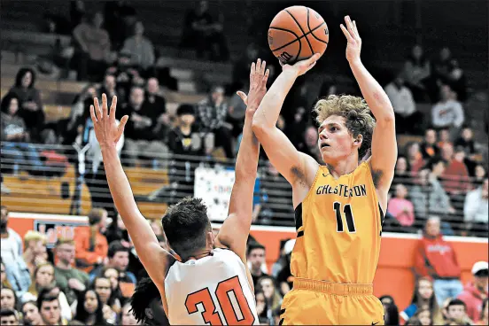  ?? KYLE TELECHAN/POST-TRIBUNE ?? Chesterton’s Tyler Nelson, right, puts a shot up over LaPorte’s Jake Spence. Chesterton along with Valparaiso are considered the two best teams in Sectional 2.