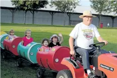  ?? MICHELLE ALLENBERG/TRIBUNE FILE PHOTO ?? Len McLaren of Niagara Antique Power Associatio­n drives a tractor with children in two in this photo from the Wainfleet Fall fair in 2015