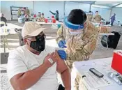  ?? STOCKER/SOUTH FLORIDA SUN SENTINEL SUSAN ?? Thomas Nelson, 51, of Miami Gardens, receives his first dose of the Pfizer Covid-19 vaccine at the FEMA-supported site at Miami Dade College North in Miami on Monday.