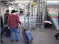  ?? Josh Galemore / Associated Press ?? Asylum seekers cross into the United States to make claims at the port of entry in Nogales, Sonora, Mexico, on Jan. 2. A federal judge on Monday blocked U.S. Customs and Border Protection employees from conducting the initial screening for people seeking asylum.