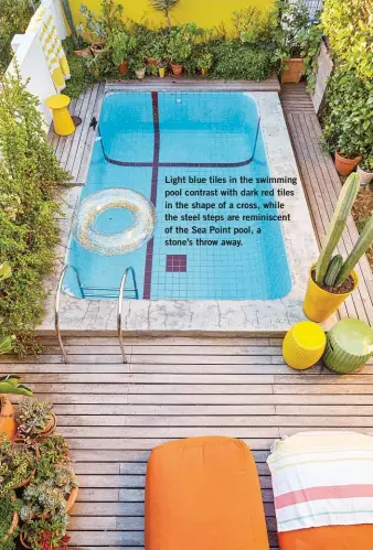  ??  ?? Light blue tiles in the swimming pool contrast with dark red tiles in the shape of a cross, while the steel steps are reminiscen­t of the Sea Point pool, a stone’s throw away.