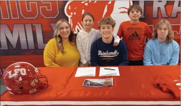  ?? Scott herpst ?? Joined by Lindsay Helton, Caleb Ownby, Zoriyanna Helton and Isaya Helton, LFO senior football player Gabe Helton signed his letter of intent to join the program at Reinhardt University last Wednesday afternoon.