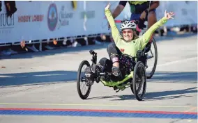  ?? ?? Andrea Peet finishes the Oklahoma City Memorial Marathon on Sunday. Peet, who was diagnosed with ALS in 2014, has a goal of riding her recumbent trike in marathons in all 50 states. Oklahoma was her 43rd.