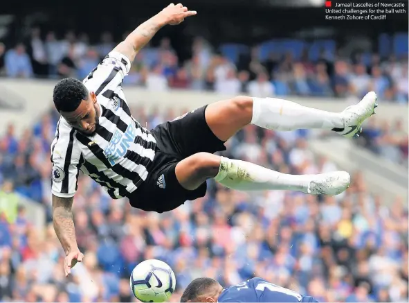  ??  ?? Jamaal Lascelles of Newcastle United challenges for the ball with Kenneth Zohore of Cardiff