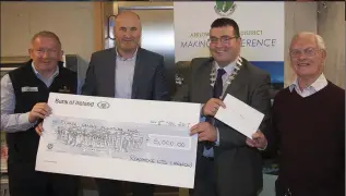  ??  ?? Pat Brennan and Alan Gerathy from Roadstone present a cheque for €5,000 to Cllr Tommy Annesley, while Michale Barnes also makes a donation towards the Ronnie Delany sculpture.