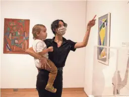  ?? SEAN LOGAN/THE REPUBLIC ?? AJ Torres holds her son, Myles Fattaleh, 1, while looking at an exhibit at the Phoenix Art Museum during its reopening on Oct. 14 in Phoenix.