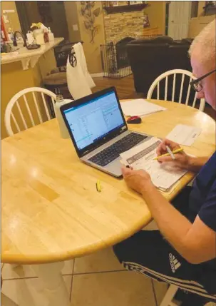  ?? Courtesy photo ?? Yuba City resident Jerry Fish works on his annual March Madness tournament pool leading up to Selection Sunday, March 14.